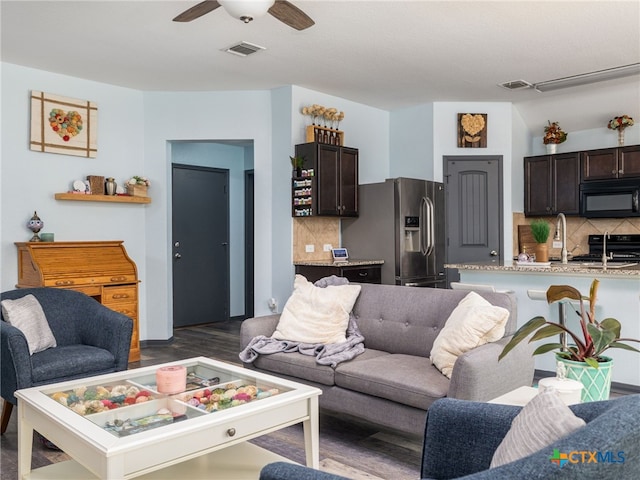 900 Hatton Hill Ln, Austin, TX 78725 - living room featuring a ceiling fan and dark wood finished floors