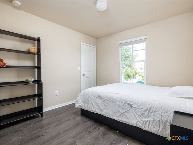 900 Hatton Hill Ln, Austin, TX 78725 - bedroom with dark wood-style floors and baseboards