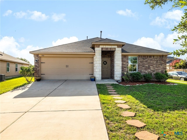 900 Hatton Hill Ln, Austin, TX 78725 - view of front facade featuring an attached garage, brick siding, driveway, and a front yard