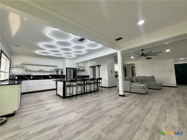 kitchen with a kitchen breakfast bar, open shelves, dark countertops, visible vents, and smart refrigerator