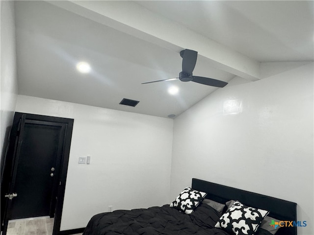 bedroom with lofted ceiling with beams, visible vents, a ceiling fan, and wood finished floors