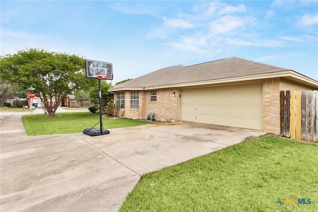 view of front of property featuring a front lawn, concrete driveway, fence, brick siding, and an attached garage