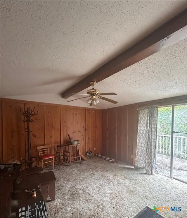 519 Baines St, Salado, TX 76571 - miscellaneous room with a textured ceiling, carpet floors, ceiling fan, beamed ceiling, and wooden walls