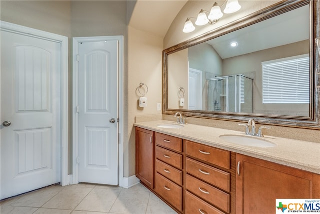 bathroom featuring vanity, vaulted ceiling, tile patterned floors, and a shower with door