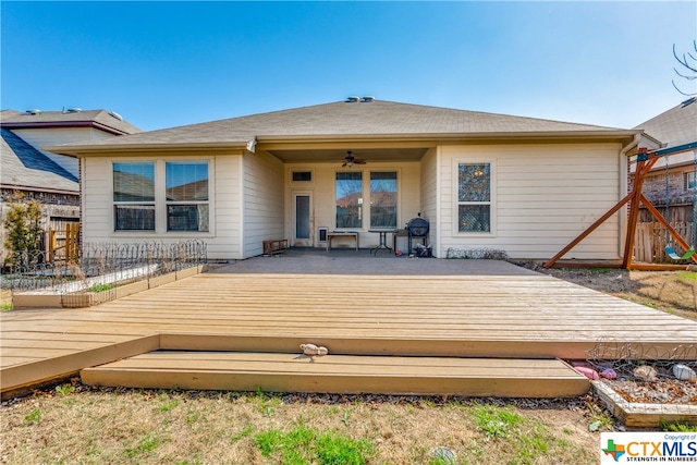 rear view of house featuring a wooden deck and ceiling fan