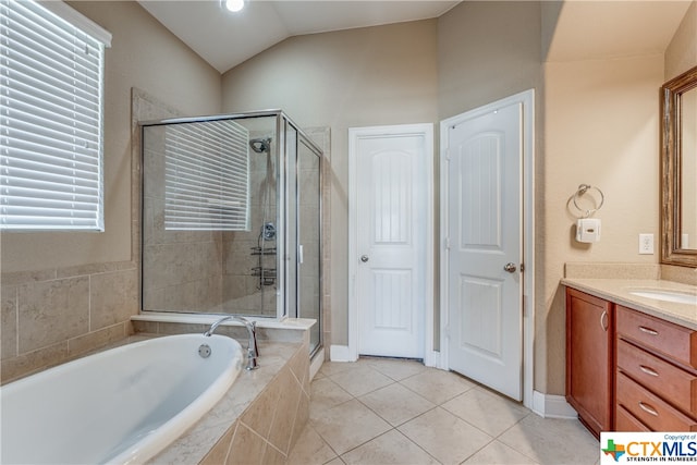 bathroom featuring tile patterned flooring, shower with separate bathtub, vanity, and vaulted ceiling