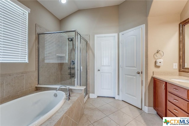 1620 Sun Ledge Way, New Braunfels, TX 78130 - full bathroom featuring vanity, a shower stall, a garden tub, tile patterned flooring, and lofted ceiling