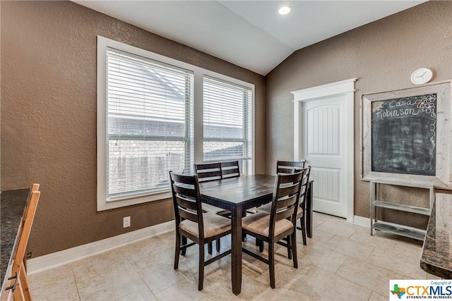 1620 Sun Ledge Way, New Braunfels, TX 78130 - dining area featuring a textured wall, vaulted ceiling, and light tile patterned flooring
