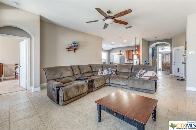 1620 Sun Ledge Way, New Braunfels, TX 78130 - living area with arched walkways, a ceiling fan, a chandelier, light tile patterned floors, and recessed lighting