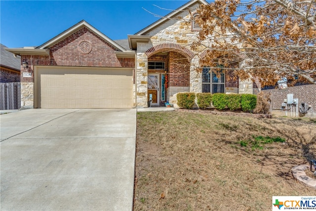 view of front facade featuring a garage and a front lawn