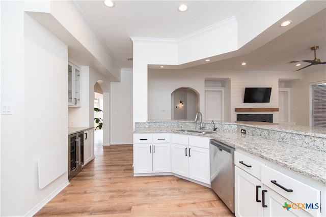 kitchen featuring sink, white cabinets, dishwasher, and light stone countertops