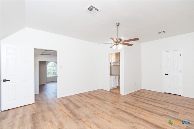 spare room with ceiling fan, light hardwood / wood-style flooring, and lofted ceiling