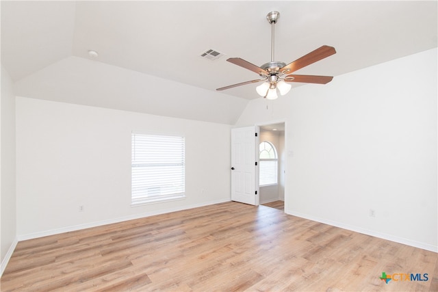 spare room featuring lofted ceiling, ceiling fan, and light hardwood / wood-style flooring