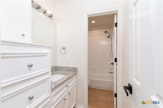 full bathroom featuring toilet, vanity, tile patterned flooring, and shower / bath combination