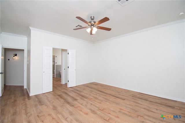 spare room featuring ceiling fan, light hardwood / wood-style floors, and crown molding