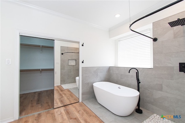 bathroom with tile walls, separate shower and tub, hardwood / wood-style floors, and crown molding