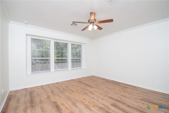 spare room featuring ornamental molding, ceiling fan, and light wood-type flooring