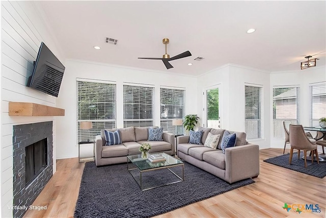 living room with ceiling fan, a healthy amount of sunlight, hardwood / wood-style floors, and crown molding