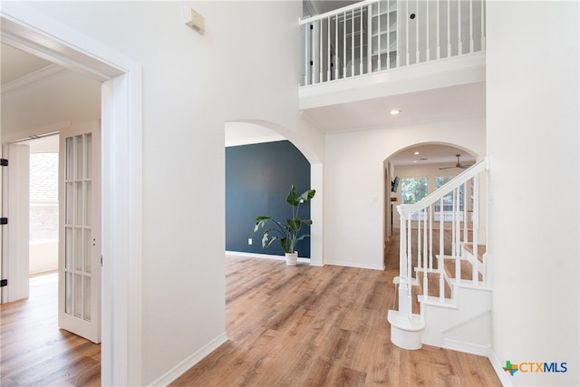 entryway featuring ceiling fan, crown molding, and wood-type flooring