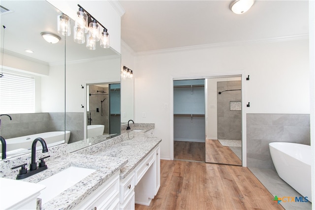 bathroom with wood-type flooring, vanity, crown molding, and plus walk in shower