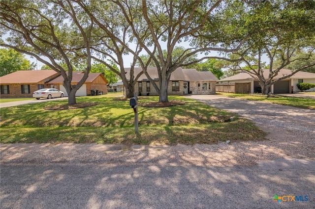 313 Pheasant Dr, Victoria, TX 77905 - ranch-style house with driveway and a garage