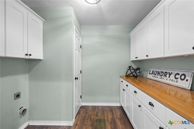 313 Pheasant Dr, Victoria, TX 77905 - washroom featuring cabinet space, baseboards, electric dryer hookup, and dark wood finished floors