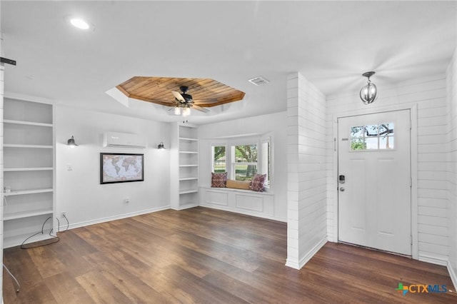 313 Pheasant Dr, Victoria, TX 77905 - entryway with a wall mounted AC, plenty of natural light, and wood finished floors