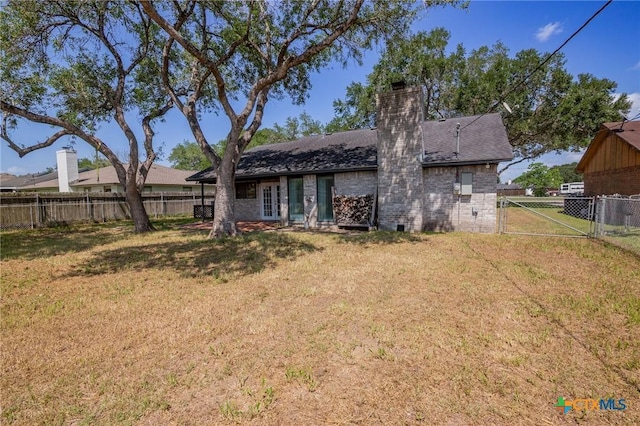 313 Pheasant Dr, Victoria, TX 77905 - rear view of property with a chimney, brick siding, a gate, and a shingled roof