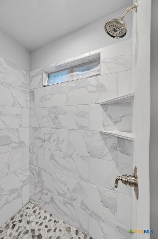 bathroom with a tile shower