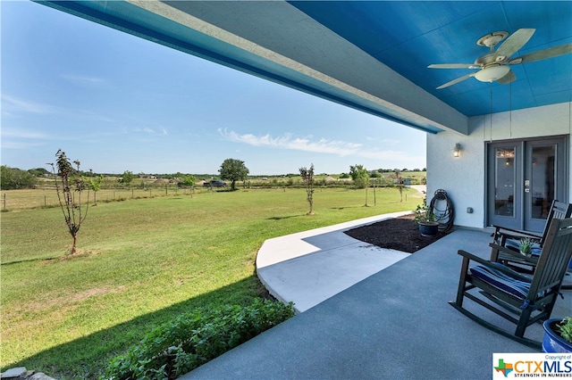 view of patio / terrace featuring a rural view and ceiling fan