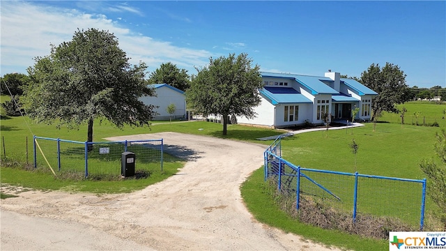 view of front facade featuring a rural view and a front lawn