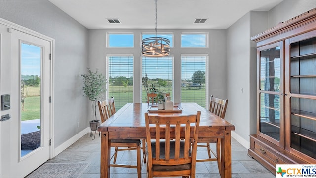 dining room with a notable chandelier and a healthy amount of sunlight