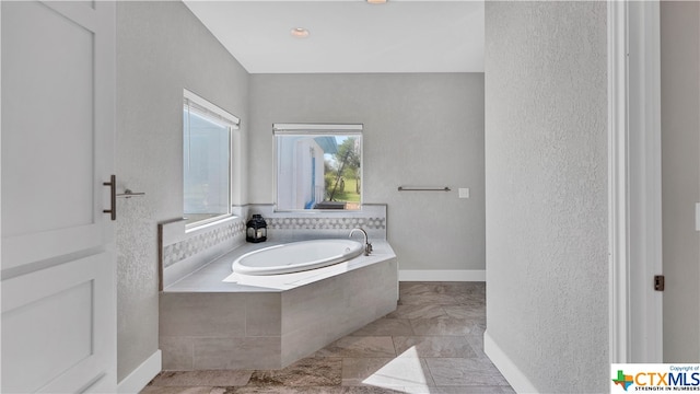 bathroom with tiled tub