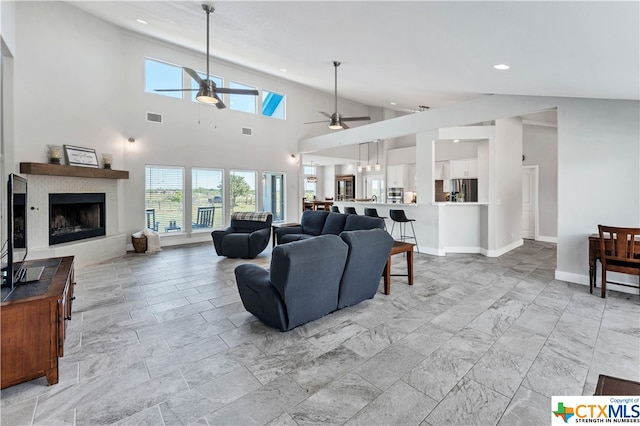 living room featuring high vaulted ceiling and ceiling fan