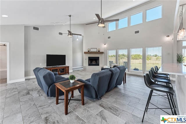 living room with high vaulted ceiling and ceiling fan