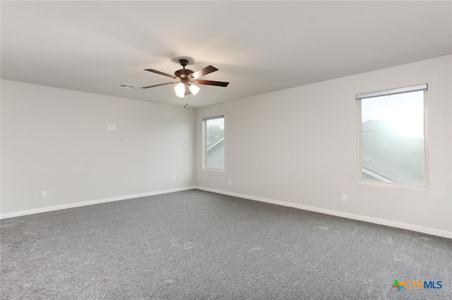 carpeted spare room with ceiling fan