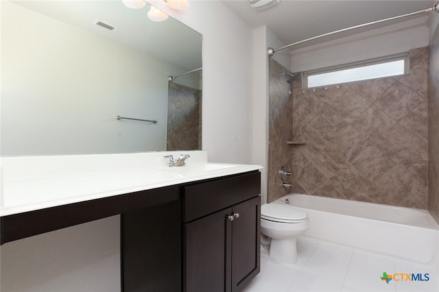 full bathroom with tile patterned floors, vanity, tiled shower / bath combo, and toilet