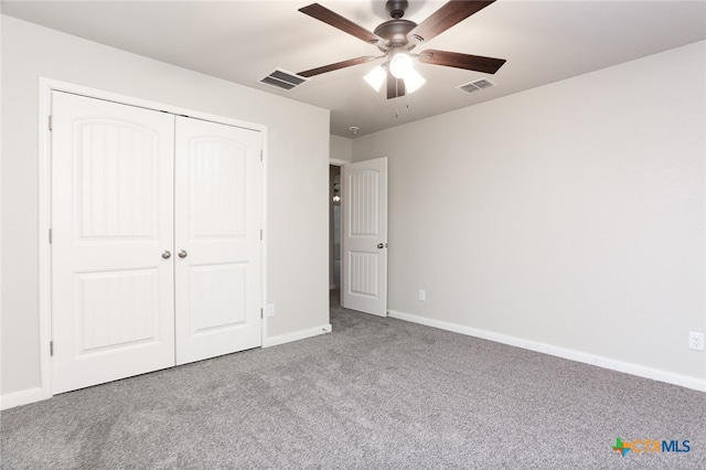 unfurnished bedroom with ceiling fan, a closet, and carpet