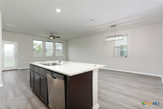 kitchen featuring dishwasher, sink, light hardwood / wood-style flooring, an island with sink, and decorative light fixtures