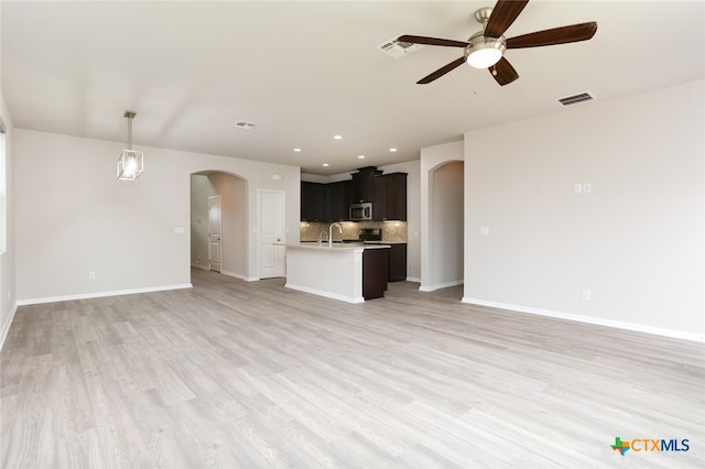 unfurnished living room with hardwood / wood-style floors and ceiling fan