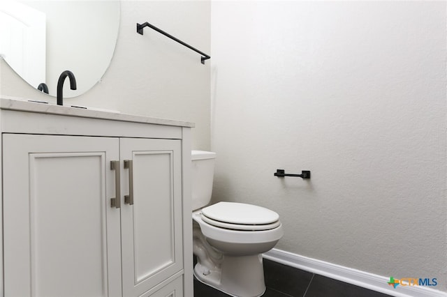 bathroom featuring toilet, vanity, and tile patterned floors