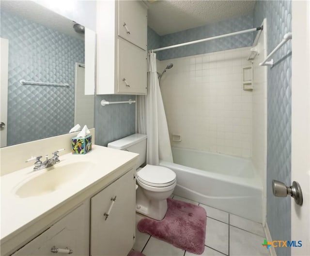 full bathroom featuring shower / tub combo, tile patterned floors, vanity, a textured ceiling, and toilet