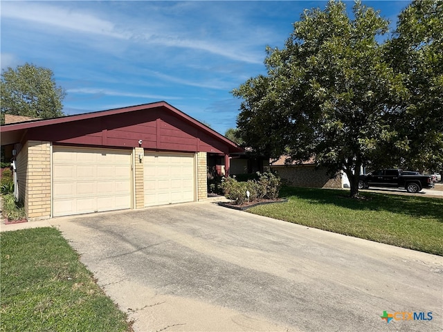 view of front facade featuring a garage, an outbuilding, and a front lawn