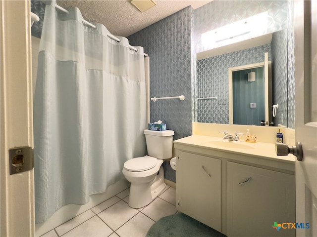 bathroom with toilet, a textured ceiling, vanity, and tile patterned floors