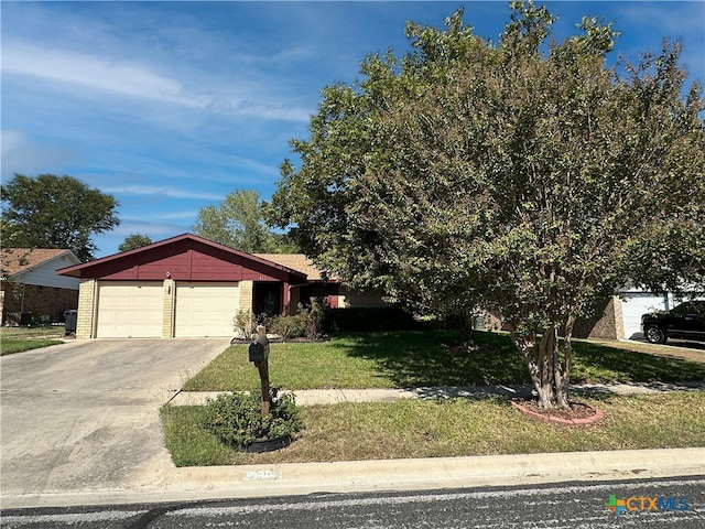 view of front of property with a garage and a front yard