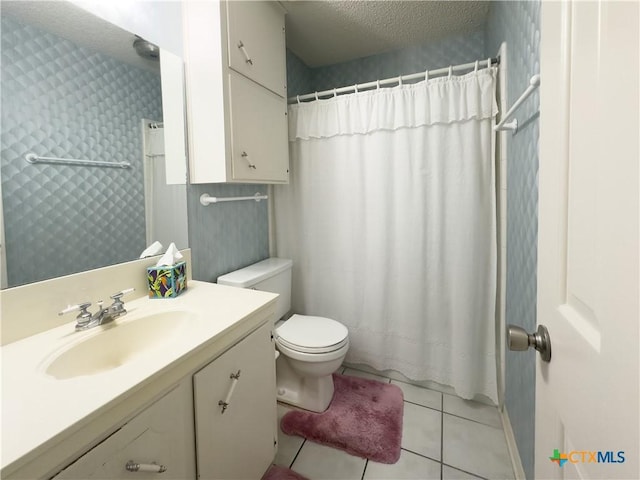 bathroom with vanity, tile patterned floors, a shower with curtain, toilet, and a textured ceiling