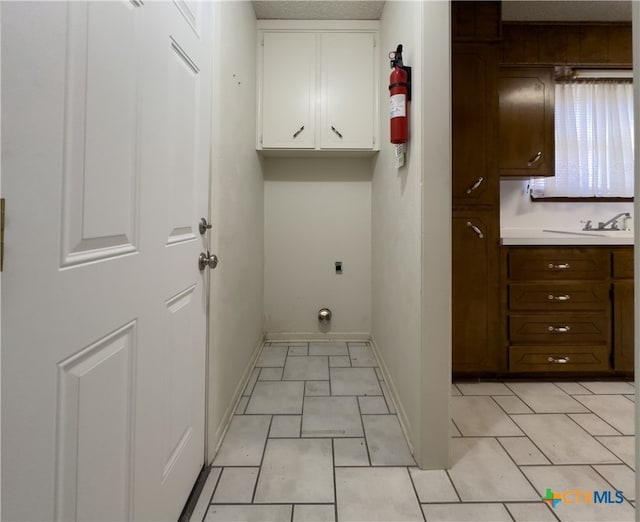 clothes washing area featuring sink, cabinets, and hookup for an electric dryer