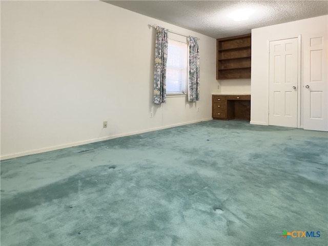 unfurnished bedroom featuring carpet and a textured ceiling