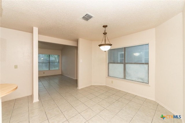 5111 Anacacho St, San Antonio, TX 78217 - unfurnished room with light tile patterned flooring, a textured ceiling, and baseboards
