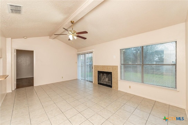 5111 Anacacho St, San Antonio, TX 78217 - unfurnished living room featuring a ceiling fan, light tile patterned floors, a tile fireplace, and a textured ceiling